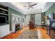 Comfortable living room with a fireplace, built-in shelving, and windows with shutters at 645 E Church St, Bartow, FL 33830