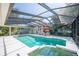 Enclosed pool with an outdoor patio and landscaping at 645 E Church St, Bartow, FL 33830