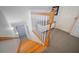 Classic staircase with wood treads and white spindles leading to carpeted landing and an alcove with bench seating at 645 E Church St, Bartow, FL 33830