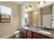 Bathroom with double sinks, granite countertop, and a tiled walk-in shower at 6527 Eagle Ridge Way, Lakeland, FL 33813