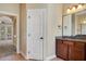 Bathroom with double vanity, granite counters, and tile floors at 6527 Eagle Ridge Way, Lakeland, FL 33813