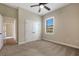 Neutral bedroom features a ceiling fan, carpeting and a closet with double doors and a window at 6527 Eagle Ridge Way, Lakeland, FL 33813