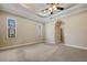 Spacious bedroom with tray ceilings, neutral paint, and carpet flooring at 6527 Eagle Ridge Way, Lakeland, FL 33813