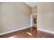 Spacious room with hardwood floors, and neutral paint, with the door leading to another room at 6527 Eagle Ridge Way, Lakeland, FL 33813