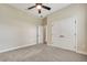 Neutral bedroom features a ceiling fan, carpeting and a closet with double doors at 6527 Eagle Ridge Way, Lakeland, FL 33813