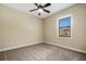 Neutral bedroom with a ceiling fan, and window with view to the outside at 6527 Eagle Ridge Way, Lakeland, FL 33813