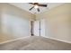 Bedroom with a ceiling fan, neutral paint, carpet flooring, and double doors to a closet at 6527 Eagle Ridge Way, Lakeland, FL 33813