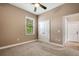 Comfortable bedroom with ceiling fan, neutral carpet, and a closet for storage at 6527 Eagle Ridge Way, Lakeland, FL 33813