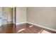 Neutral bedroom featuring beautiful hardwood floors and trim, with the door leading to another room at 6527 Eagle Ridge Way, Lakeland, FL 33813