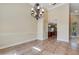 Elegant dining area featuring tile flooring, crown molding, and contemporary lighting at 6527 Eagle Ridge Way, Lakeland, FL 33813