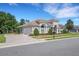 Beautiful single-story home with a tile roof, arched entry, manicured landscaping, and paved driveway at 6527 Eagle Ridge Way, Lakeland, FL 33813