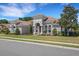 Expansive single-story home showcasing the light-colored exterior, tile roof, and manicured lawn and landscaping at 6527 Eagle Ridge Way, Lakeland, FL 33813