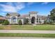 Beautiful single-story home featuring a neutral exterior, clay tile roof, and an arched front entryway at 6527 Eagle Ridge Way, Lakeland, FL 33813