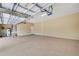 Large three-car garage featuring high ceilings, two overhead doors, and plenty of room for storage at 6527 Eagle Ridge Way, Lakeland, FL 33813