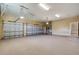 Spacious three-car garage offering ample space for vehicles and storage, including high ceilings at 6527 Eagle Ridge Way, Lakeland, FL 33813