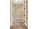 Elegant hallway with arched doorways, neutral paint, with tile and carpet flooring at 6527 Eagle Ridge Way, Lakeland, FL 33813