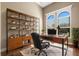 Bright home office with natural light, built-in shelves, and sleek desk setup at 6527 Eagle Ridge Way, Lakeland, FL 33813
