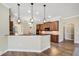 Open kitchen with granite countertops, pendant lighting, tile floor, and stainless steel appliances at 6527 Eagle Ridge Way, Lakeland, FL 33813
