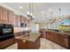 Gourmet kitchen featuring stainless steel appliances and a large kitchen island at 6527 Eagle Ridge Way, Lakeland, FL 33813