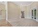 Open-concept living area with plush carpet, a view to other rooms, and access to the outdoors at 6527 Eagle Ridge Way, Lakeland, FL 33813