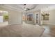 Spacious living room features tile and carpeted floors with backyard access at 6527 Eagle Ridge Way, Lakeland, FL 33813