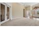 Spacious living room featuring carpet, French doors, and an archway leading to other rooms at 6527 Eagle Ridge Way, Lakeland, FL 33813