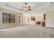 Open concept living room features tile and carpeted floors with backyard access at 6527 Eagle Ridge Way, Lakeland, FL 33813