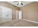 Comfortable bedroom with carpet flooring, neutral walls, base trim, and large double doors for storage at 6527 Eagle Ridge Way, Lakeland, FL 33813