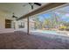 Spacious patio area with ceiling fans and views of the pool, yard, and nearby trees at 6527 Eagle Ridge Way, Lakeland, FL 33813