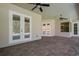 Open-air patio with stone flooring and French doors leading to the house at 6527 Eagle Ridge Way, Lakeland, FL 33813
