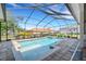 Sparkling screened pool with a tanning ledge surrounded by brick flooring at 6527 Eagle Ridge Way, Lakeland, FL 33813