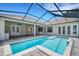 Inviting screened pool area with patio, tiled flooring, and multiple access points to the house at 6527 Eagle Ridge Way, Lakeland, FL 33813