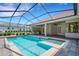Inviting screened pool area with patio and relaxing hot tub surrounded by brick flooring at 6527 Eagle Ridge Way, Lakeland, FL 33813