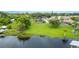 Expansive lakefront property featuring lush green lawns and mature trees at 7016 Summit Cir, Winter Haven, FL 33884
