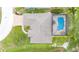 Aerial view of house featuring screened-in pool and well-maintained landscaping at 7016 Summit Cir, Winter Haven, FL 33884
