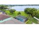Aerial view of backyard featuring screened-in pool, palm trees and lush lawn at 7016 Summit Cir, Winter Haven, FL 33884