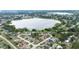 Residential community with a scenic lake surrounded by lush greenery at 7016 Summit Cir, Winter Haven, FL 33884