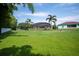 Expansive backyard with manicured lawn and screened-in pool at 7016 Summit Cir, Winter Haven, FL 33884