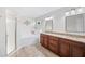 Bathroom featuring double vanity, glass shower and tub at 7016 Summit Cir, Winter Haven, FL 33884