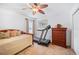 Cozy bedroom featuring a daybed, ceiling fan, and artwork at 7016 Summit Cir, Winter Haven, FL 33884