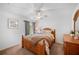 Serene bedroom with a full-sized bed, soft lighting, and neutral decor, completed with a ceiling fan at 7016 Summit Cir, Winter Haven, FL 33884
