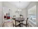 Cozy breakfast nook near a bedroom featuring a round table and chairs under an elegant pendant light at 7016 Summit Cir, Winter Haven, FL 33884
