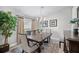Traditional dining room featuring a decorative rug, stylish chandelier, and sunlit window with elegant curtains at 7016 Summit Cir, Winter Haven, FL 33884