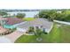 Exterior of home with brick driveway, well-manicured lawn and view of lake at 7016 Summit Cir, Winter Haven, FL 33884