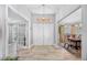 Elegant foyer with tile floors, a chandelier, and views into the dining and living areas at 7016 Summit Cir, Winter Haven, FL 33884