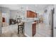 Open-concept kitchen boasts bar seating, stainless steel appliances, and seamless flow to dining and living areas at 7016 Summit Cir, Winter Haven, FL 33884