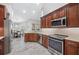 Updated kitchen with stainless appliances, granite countertops, wood cabinets, and seamless flow to the dining area at 7016 Summit Cir, Winter Haven, FL 33884