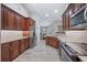 Modern kitchen featuring granite countertops, wood cabinets, stainless steel appliances and wood-look tile flooring at 7016 Summit Cir, Winter Haven, FL 33884