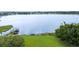 A lake view with a dock surrounded by lush greenery at 7016 Summit Cir, Winter Haven, FL 33884