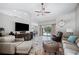 Comfortable living room with tile floors, vaulted ceilings, and views of the pool at 7016 Summit Cir, Winter Haven, FL 33884